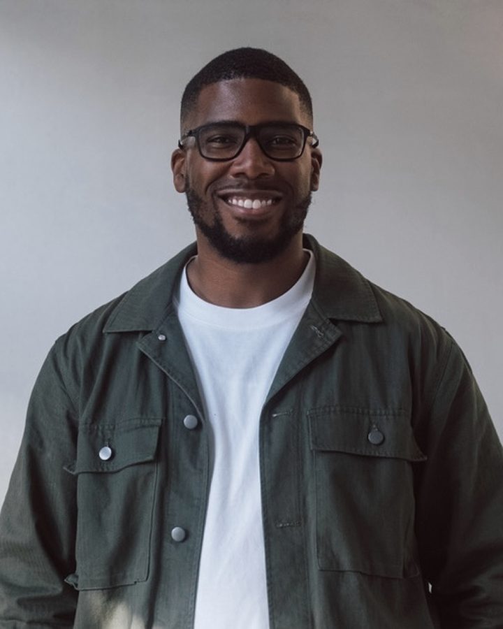 A founder portrait, shot against a plain studio wall